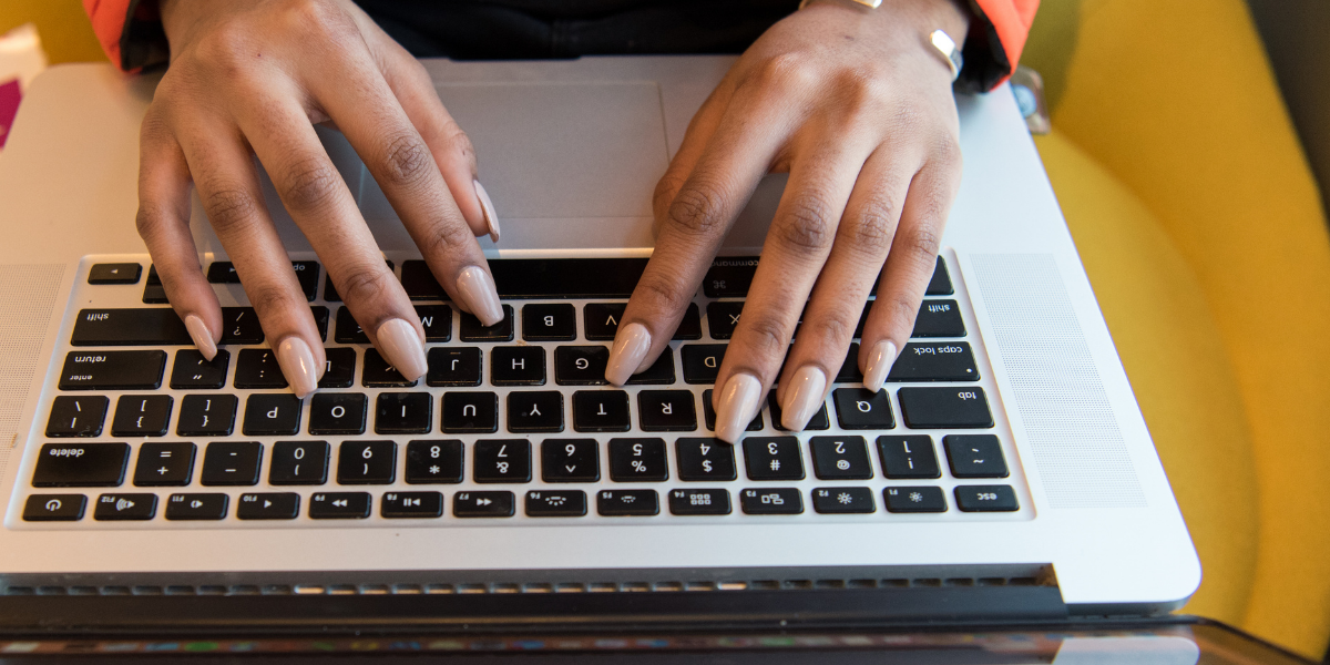 African American Female typing on laptop