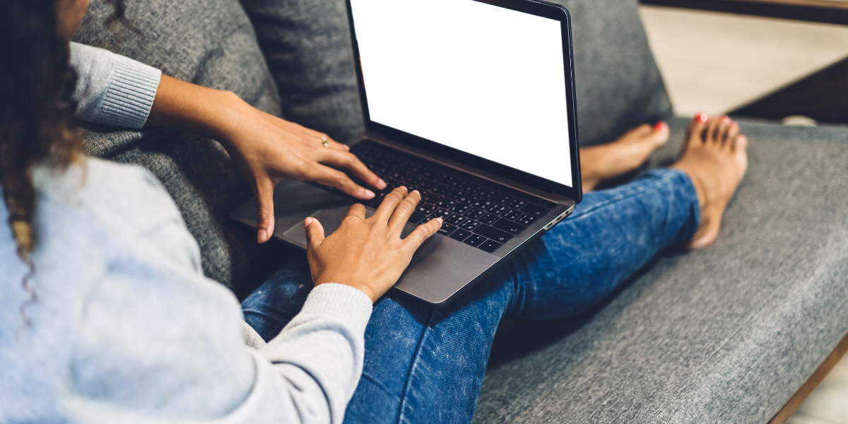 woman sitting on couch with laptop batch creating content