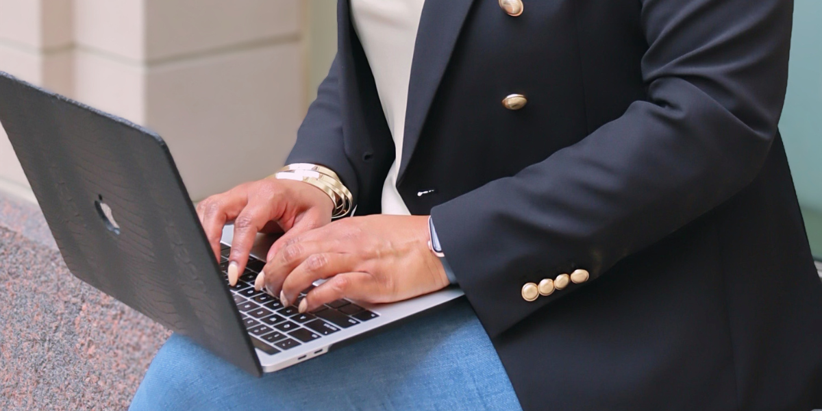 Woman solopreneur typing on laptop