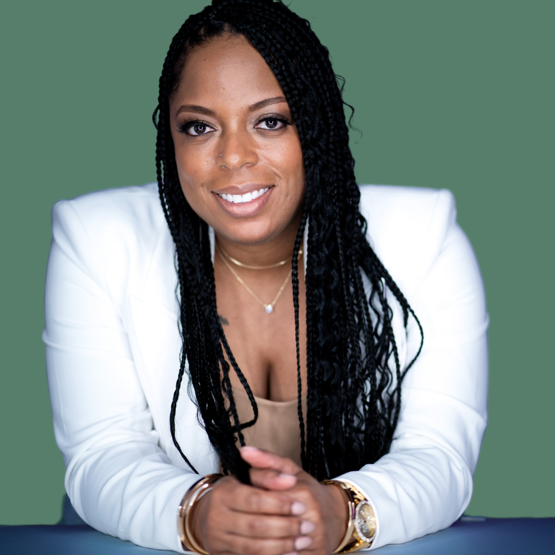 African American business woman solopreneur sitting down in white blazer
