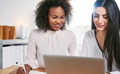 Two ambitious women associates working together to discuss team collaboration tools